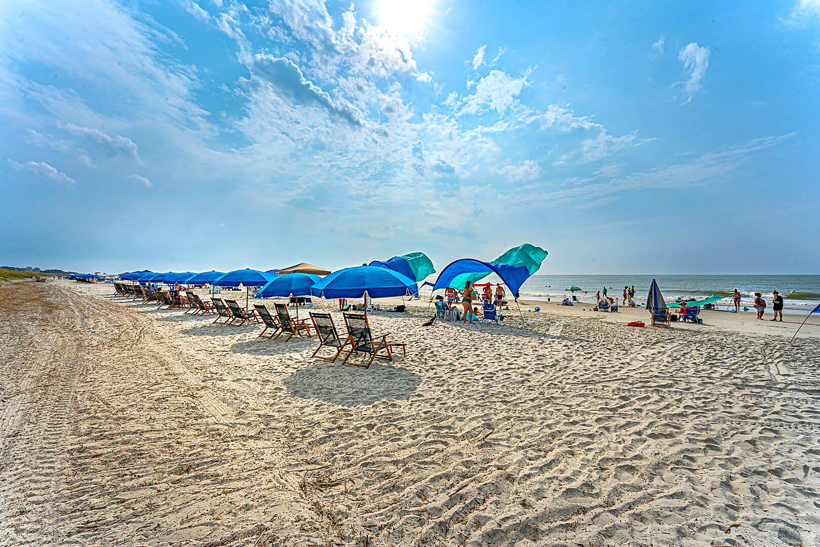 Wide hard-packed sand and rental umbrellas on the north end of Hilton Head Island in summer